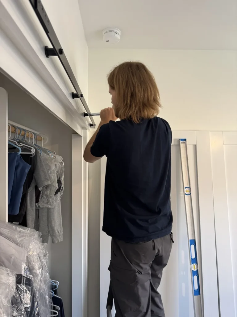 Sliding barn door rail installation in closet